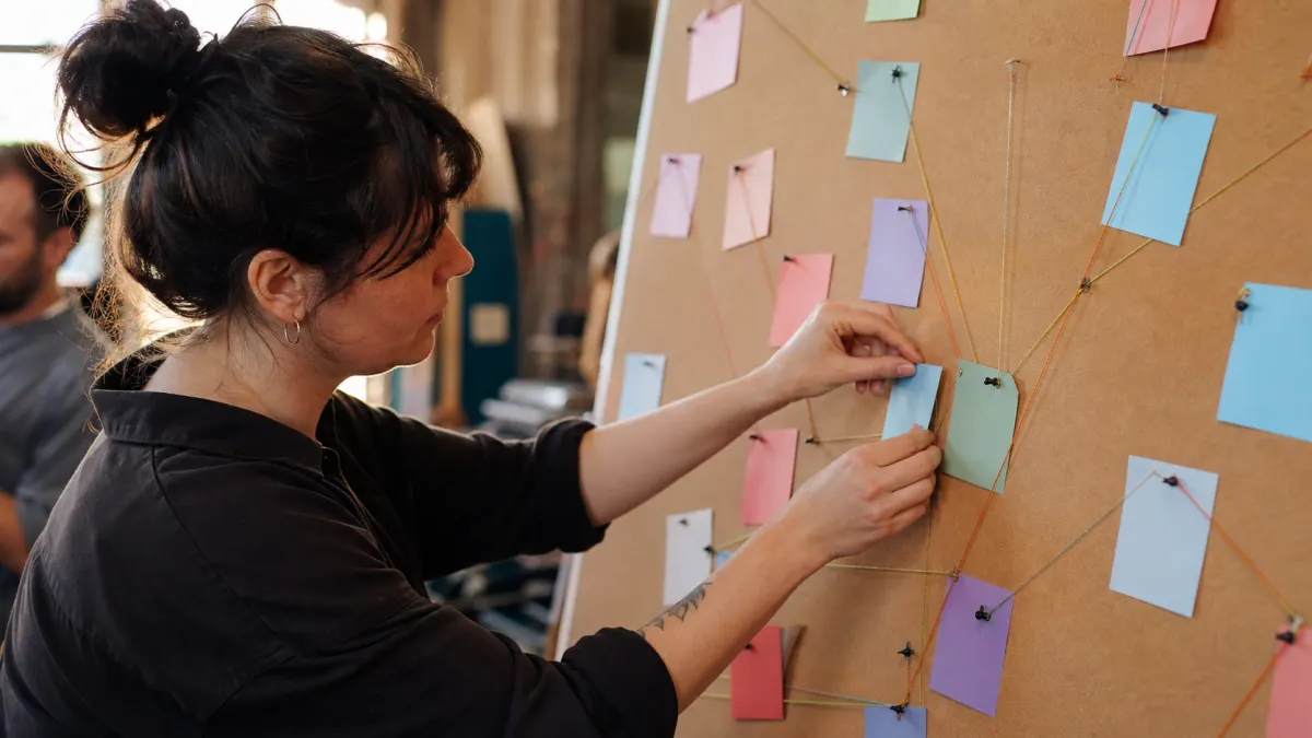 Facilitator maps blank cards while planning a json to markdown output structure.
